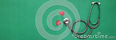 Close up red heart white stethoscope on green Doctor table.health concept. Stock Photo