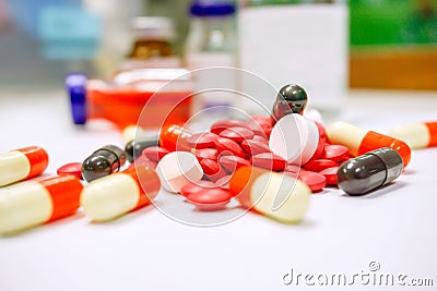 Close up of Red pill medicines and capsule place on white table with ampule blurry background Stock Photo