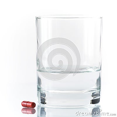 Close up of red pill and water Stock Photo