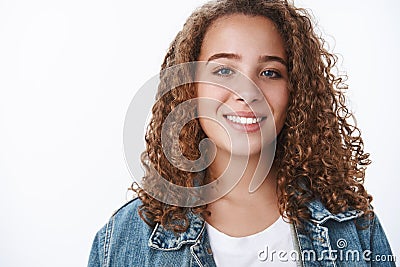 Close-up relaxed carefree smiling happy plump young curly-haired female student grinning delighted standing casually Stock Photo