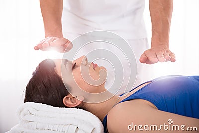 Woman Having Reiki Healing Treatment Stock Photo