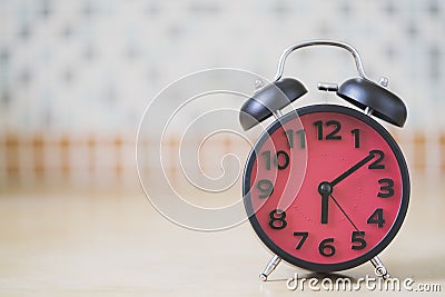 Close up of retro alarm clock on table in the morning Stock Photo