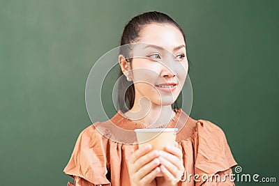 Close-up right side of beautiful Asian woman customer happy to drink hot coffee and looks at left side in coffee bar Stock Photo