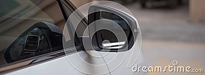 A partial close-up of the right side mirror of a white Citroen C5 aircross SUV Stock Photo