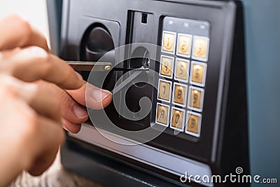 Hand Trying To Break Home Security Safe Stock Photo