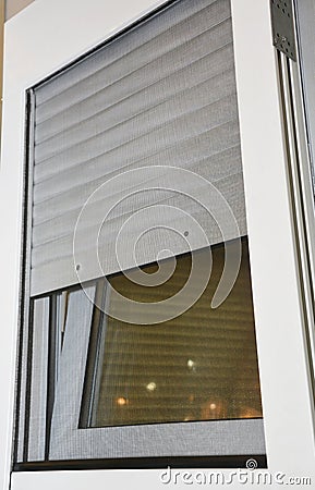 Close up on rolling shutters house windows protection with mosquito net screen Stock Photo