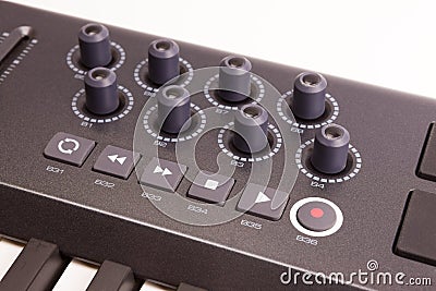 Close-up of a row of knobs on a MIDI controller Keyboard Stock Photo