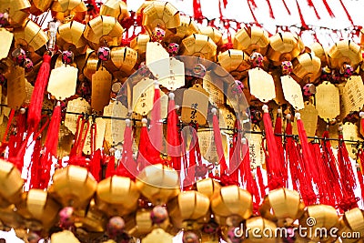 Close up rows Devotees hanging golden prayer bells for blessing at at Wong Tai Sin Temple, Hong Kong Stock Photo