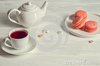 Close up. Rustic still life. Provence breakfast. Color living coral. Bright macarons on a round plate Stock Photo