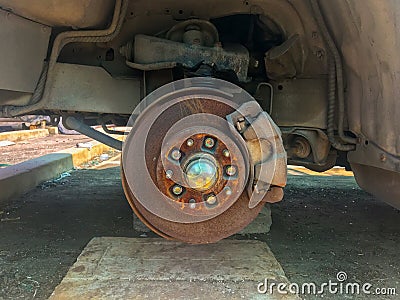 rusty broken car with missing wheel Stock Photo