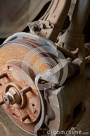 close-up of rusty disk brake, steering knuckle and suspension Stock Photo