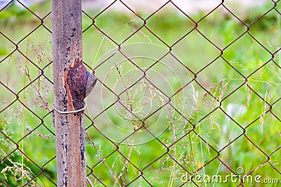 Close up on Old Rusty Metal Fence. Rusty steel wire mesh fence in the garden Stock Photo