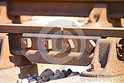 Close up of rusty railway track showing the nuts and bolts of the fishplate which joins sections of track Stock Photo