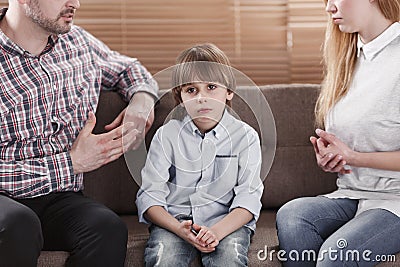 Sad child while parents arguing Stock Photo