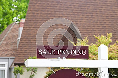 Close up of SALE PENDING sign in front of house Stock Photo