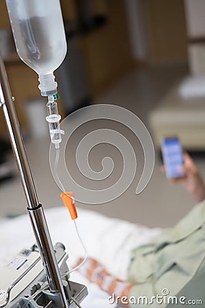 Close up saline drip for patient in hospital room. Stock Photo