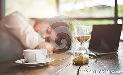 Close up of sandglass with business woman tired from working wit Stock Photo