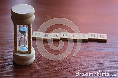 Close up of sandglass and wooden cube Stock Photo