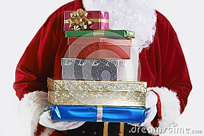 Close Up Of Santa Claus Holding Pile Of Gift Wrapped Presents Stock Photo