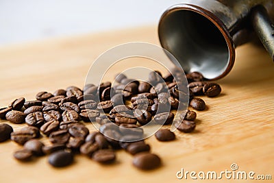 Close-up of a scattering of coffee beans on a wooden board Stock Photo