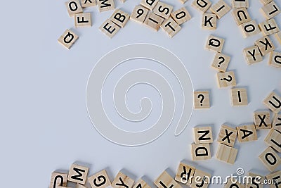 close-up of scattering of wooden squares with letters, empty space for the designer, light background, quantitative indicator Stock Photo