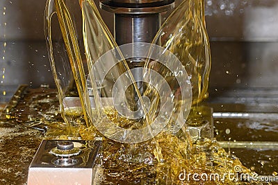 Close up scene the CNC milling machine drilling the tire mold parts with oil coolant method Stock Photo