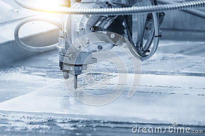 Close-up scene of multi-axis abrasive waterjet cutting machine cutting the aluminum plate Stock Photo