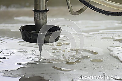 Close-up scene of multi-axis abrasive waterjet cutting machine cutting the aluminum plate Stock Photo