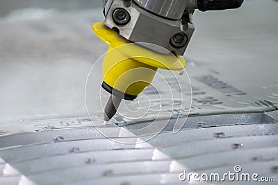 Close-up scene of multi-axis waterjet cutting machine cutting the aluminum plate Stock Photo