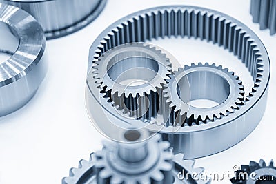 The close-up scene of planetary gear parts of automatic transmission gear box in the light blue scene. Stock Photo