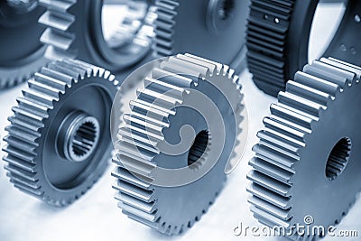 The close-up scene of various type of the pinion gear parts shaft in the light blue scene. Stock Photo