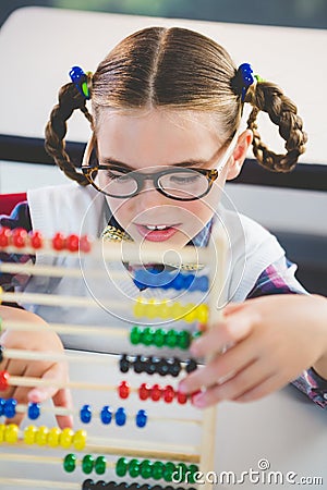 Close-up of schoolkid counting abacus in classroom Stock Photo