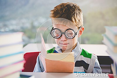 Close-up of schoolkid reading book in classroom Stock Photo