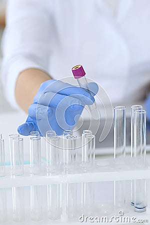 Close up of scientific research hands with clear solution in laboratory Stock Photo