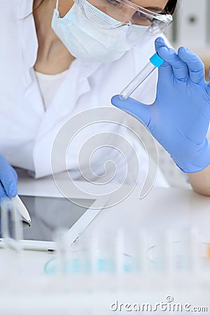 Close up of scientific research hands with clear solution in laboratory Stock Photo