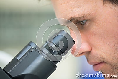 Close up of a scientific researcher using microscope Stock Photo