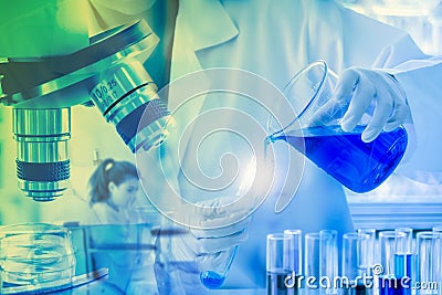 Close up, scientist dropping blue liquid into test tubes Stock Photo