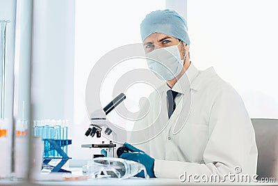 Close up. scientist looking into the eyepiece of a microscope. Stock Photo