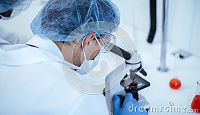Close up. scientist looking through a microscope. Stock Photo