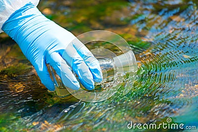 Close up of a scientist`s river drawing water into a research flask Stock Photo