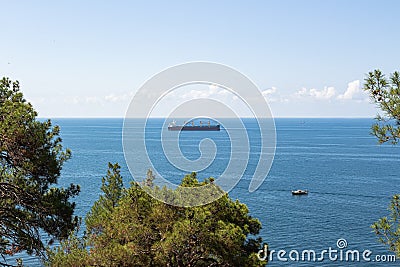 Close-up of the seascape. Blue sea, clouds over the horizon and cargo ships Stock Photo