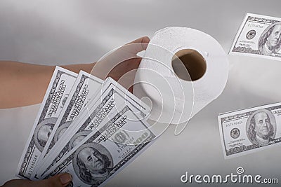 Close up sell buy tissue, hand holds toilet paper tissue and money of 100 US dollars banknote a lot of, That was It costs Stock Photo