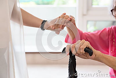 Close up of senior woman and young woman holding hand ,people,age,family,care and support concept Stock Photo
