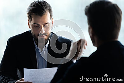 Close up serious businessman reading cv new job candidate. Stock Photo