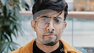 Close-up serious dissatisfied young arab guy student standing indoors looking at camera negatively shaking head says no Stock Photo
