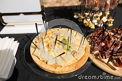 The close up of a set of canapes and snack at a banquet with black table Stock Photo