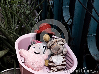 Close-up of several character dolls in a white basket Stock Photo