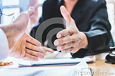Close-up Shake hands lawyers in office. Counseling and Give an advice between private and government officials to find a fair Stock Photo