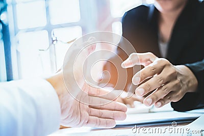 Close-up Shake hands lawyers in office. Counseling and Give an advice between private and government officials to find a fair Stock Photo