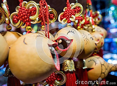 Close-up, shallow depth-of-field view of some hanging souvenir trinkets from a street stall Editorial Stock Photo